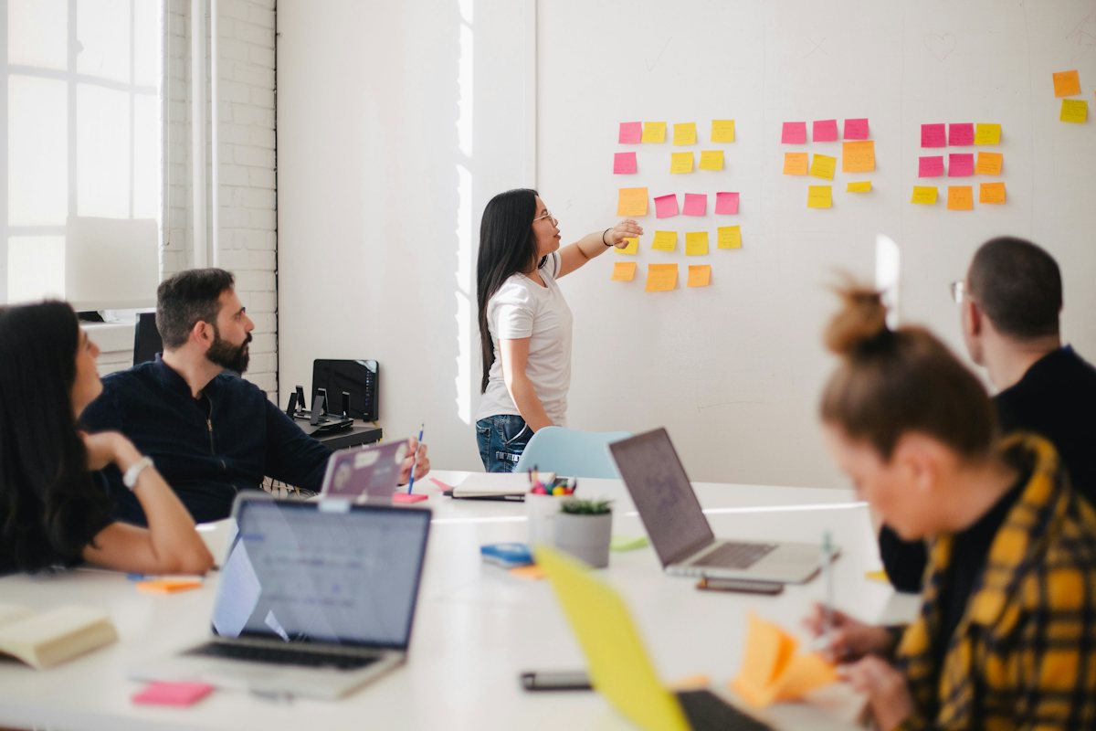 A team planning together in front of a wall of sticky notes